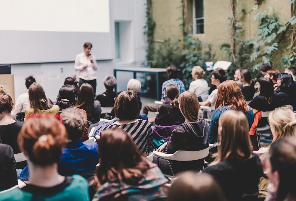 Speaker in front of audience at conference