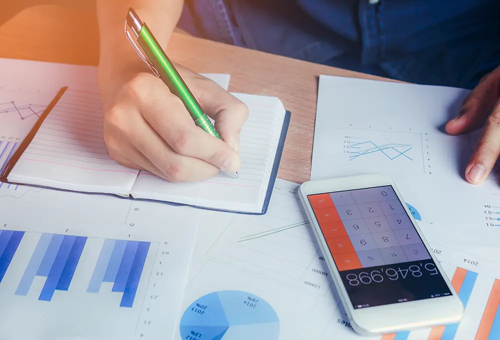 Accountant working at a desk with notebook and calculator